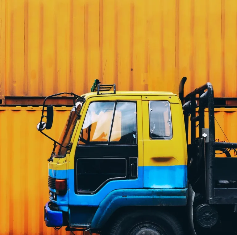 yellow-truck-parked-near-yellow-container-box