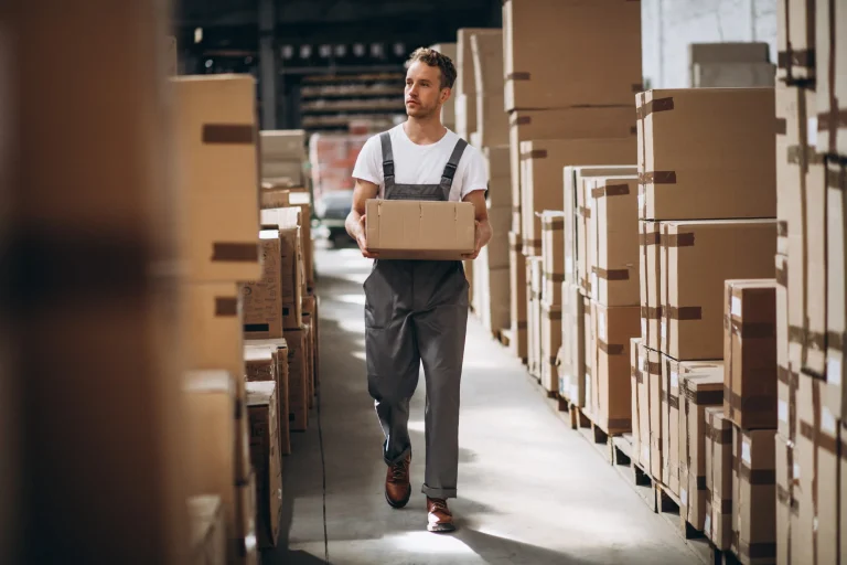 young-man-working-warehouse-with-boxes