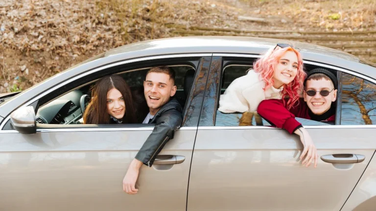 young-men-women-looking-out-car-window